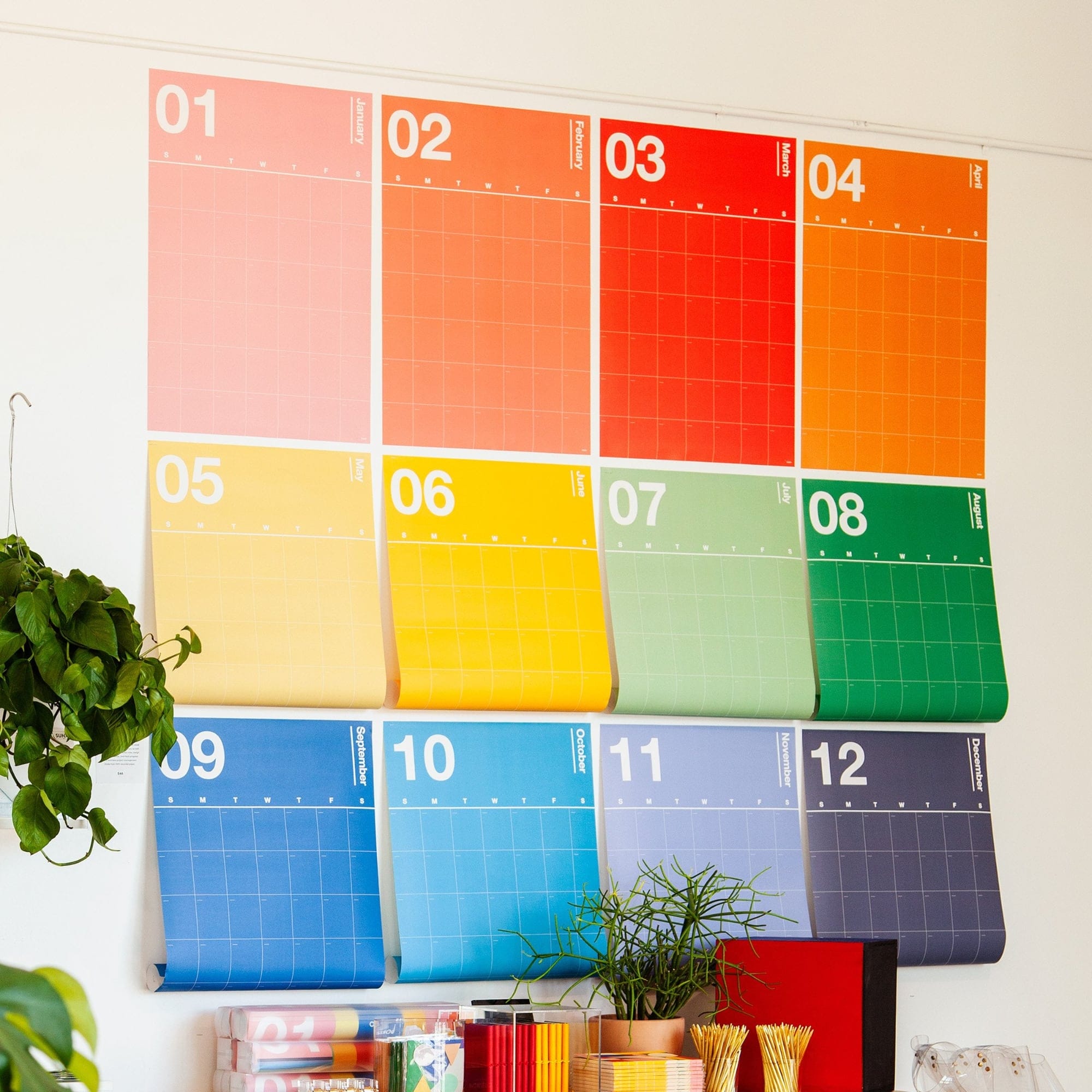 A photo of colorful calendars on a wall