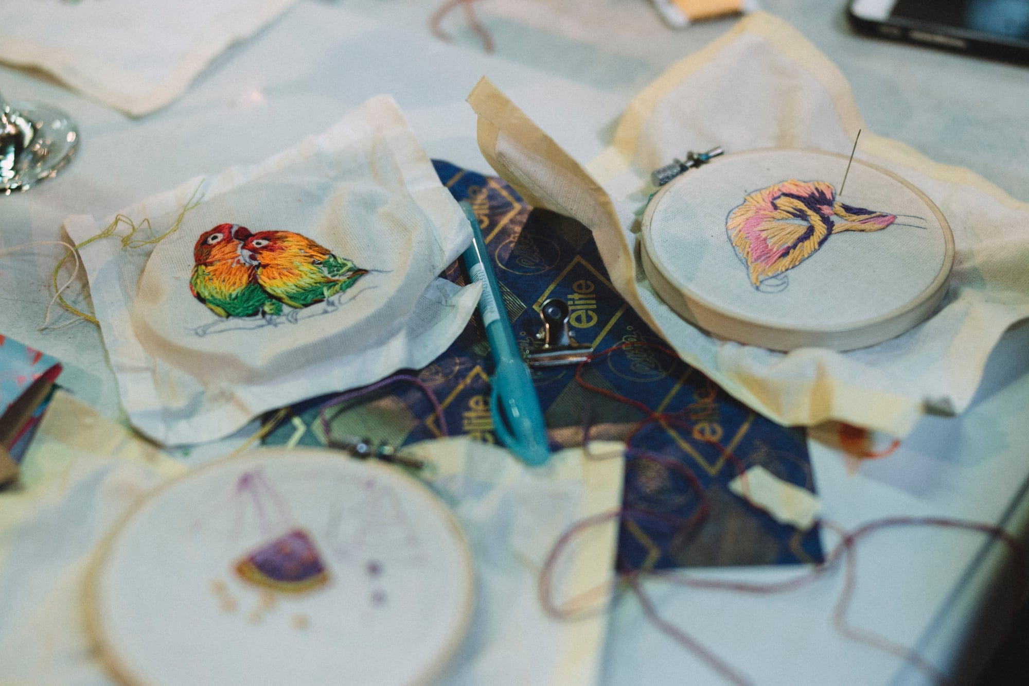 Embroideries of birds and flowers on a table