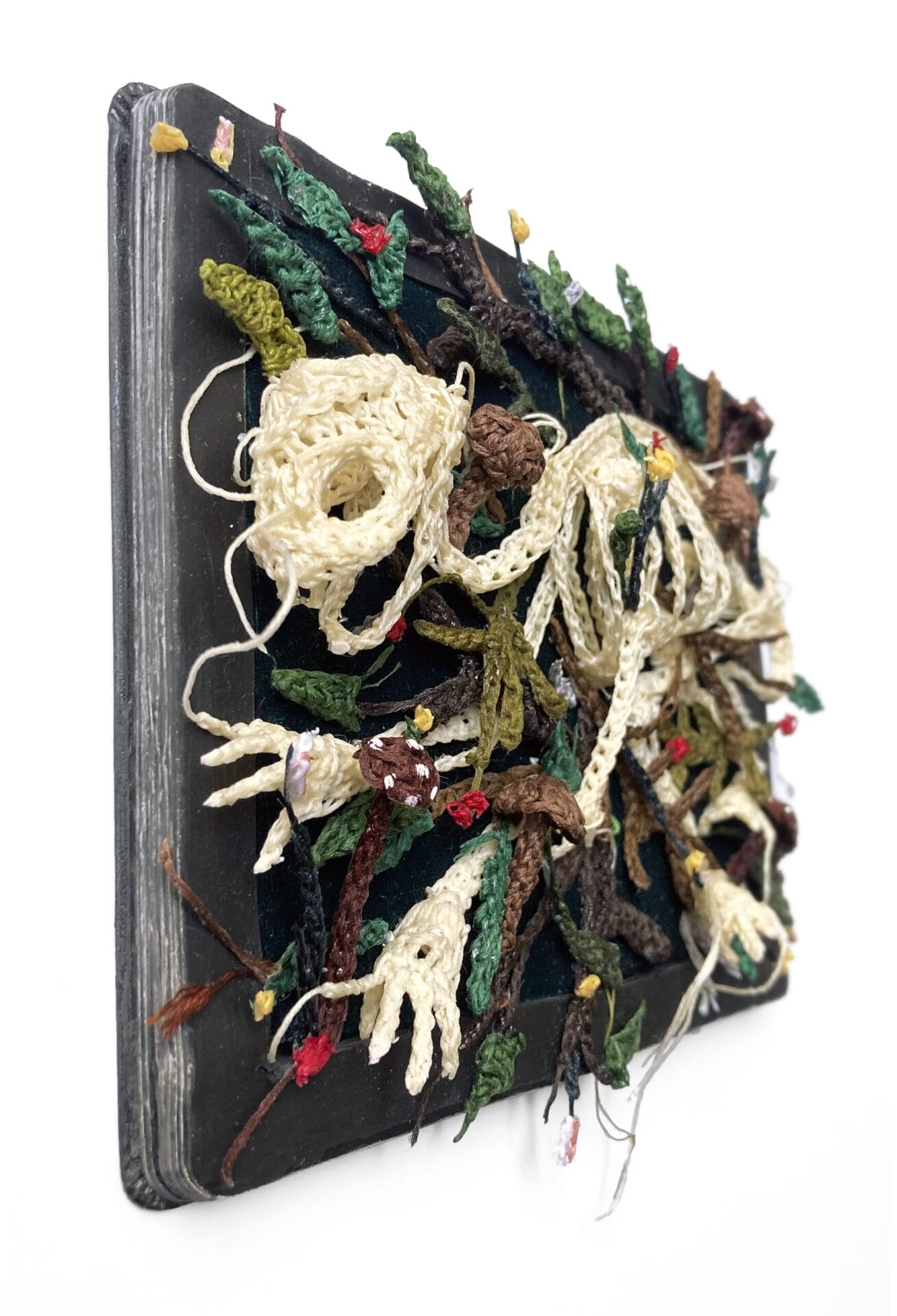 Crocheted fiber that looks like tiny skeletons on the ground.