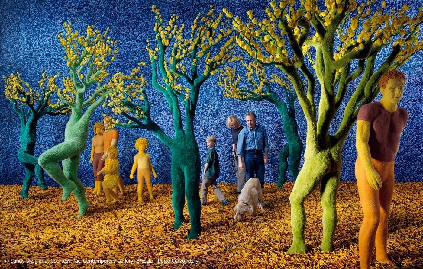 A surreal fine art photograph of a family out walking their dog in a forest where the trees have the bodies of humans.