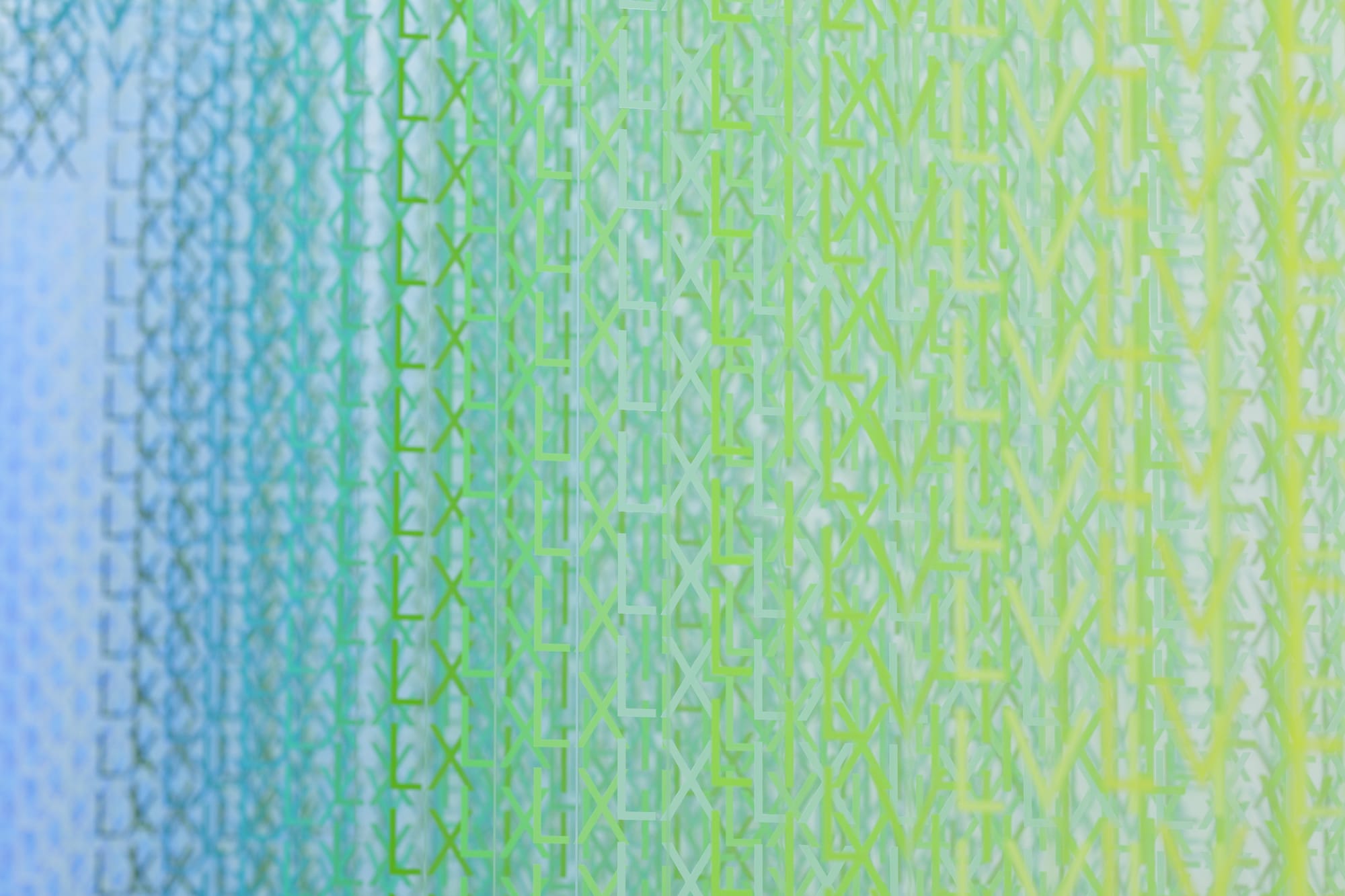 A detail of a large-scale installation of thousands of colorful Roman numerals, showing mostly green-blue letters.