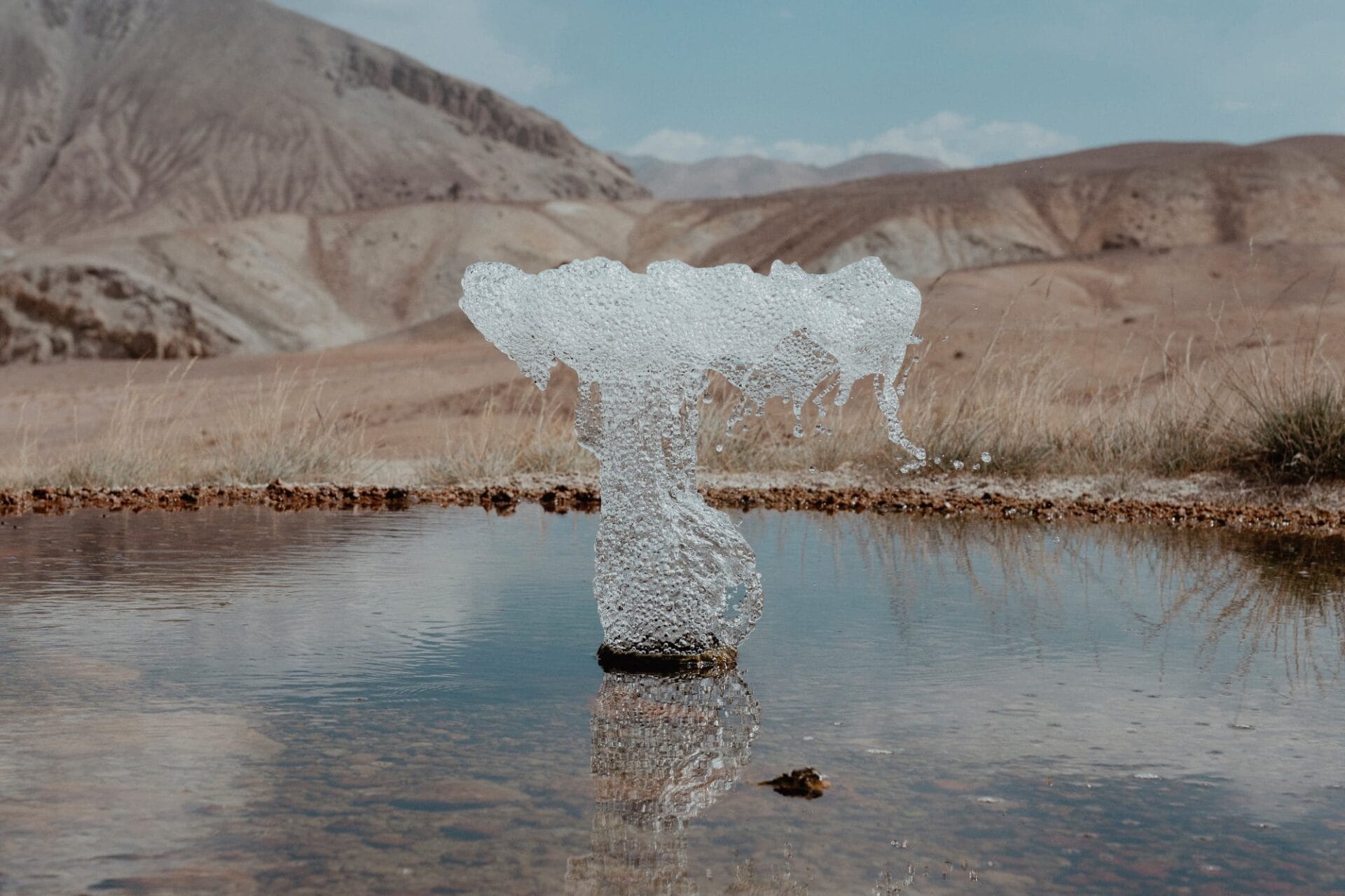 a mushroom like ice formation on a small body of water