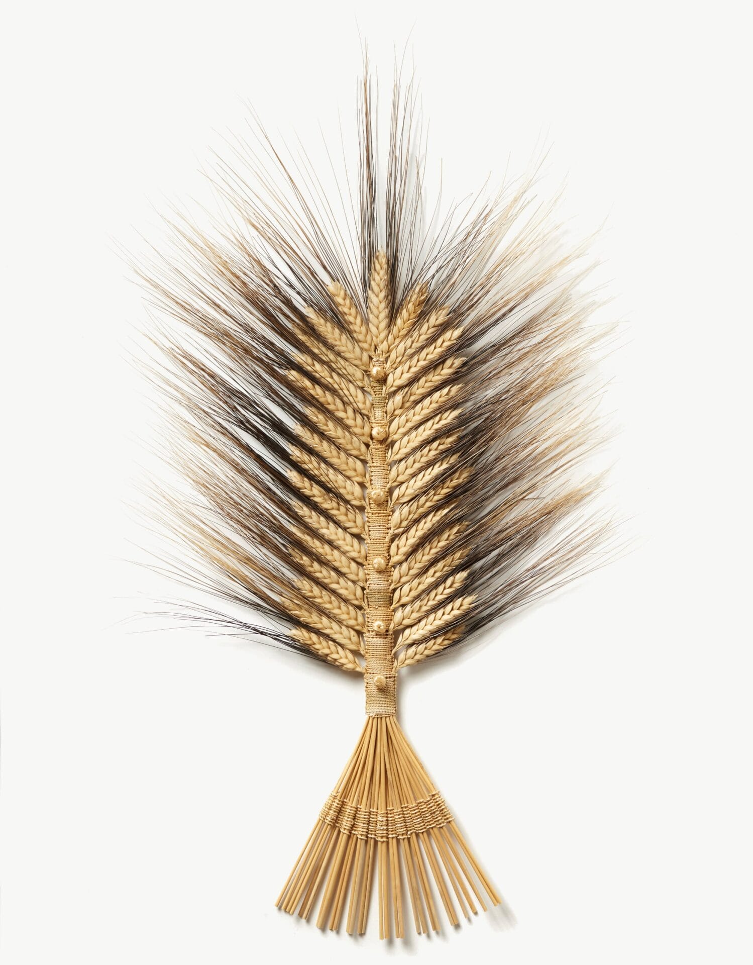 a small wheat wall sculpture with braided and woven pieces