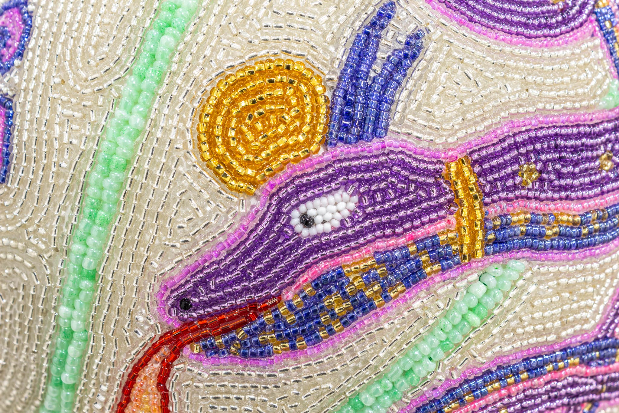 a detail shot of a purple beaded snake