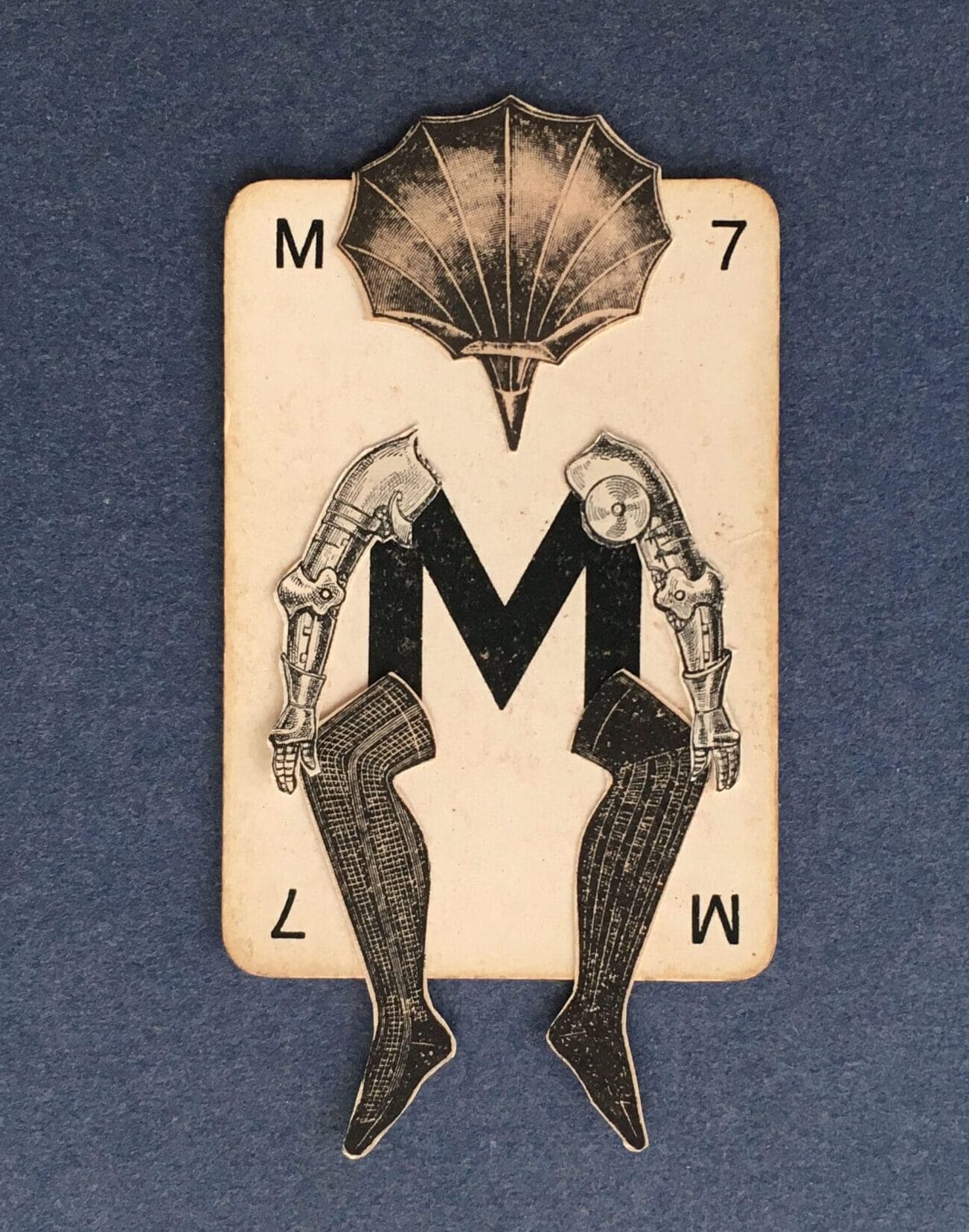 paper legs and arms are collaged onto a vintage playing card, and the figure has a shell for a head