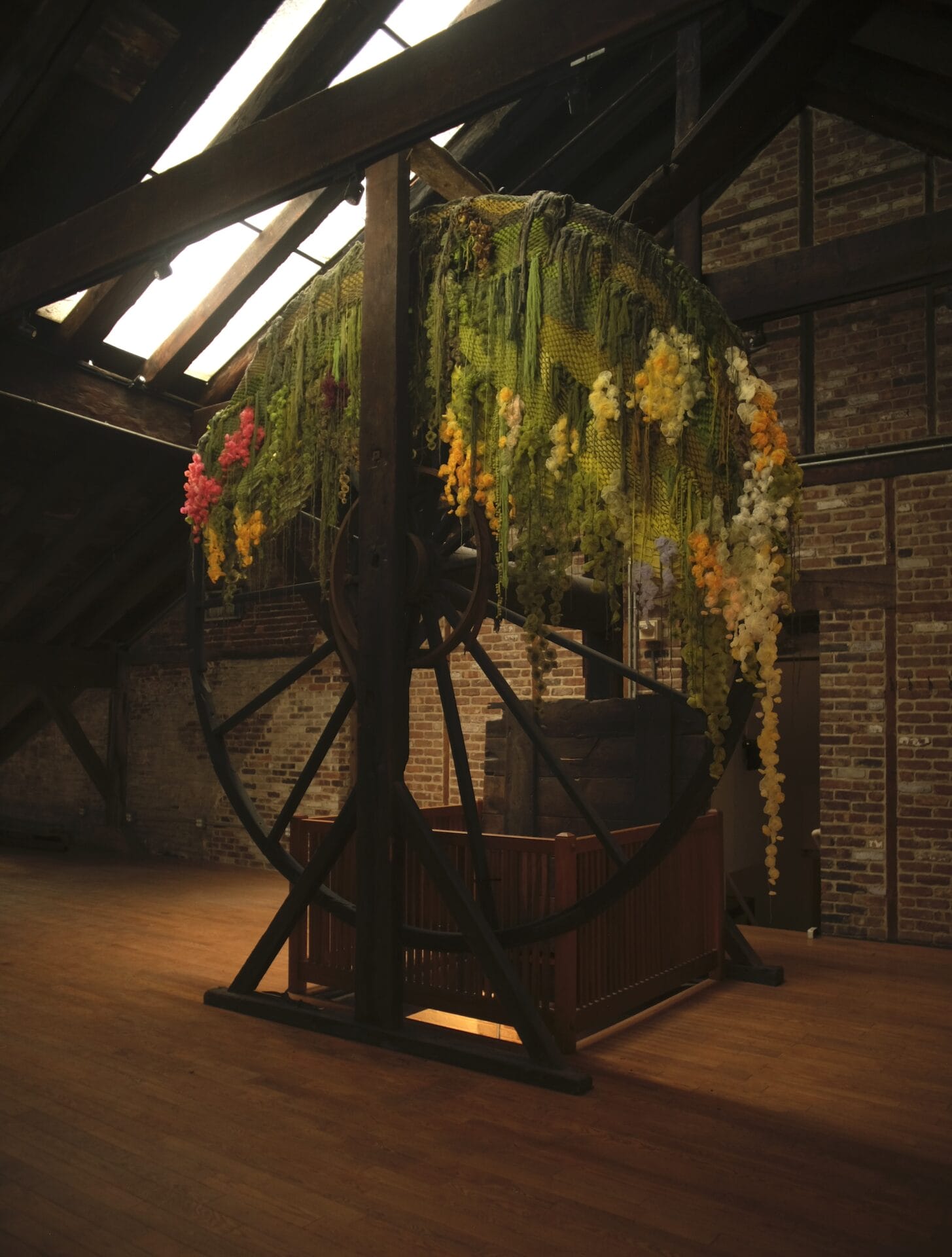 a wheel with floral thread sculptures on top