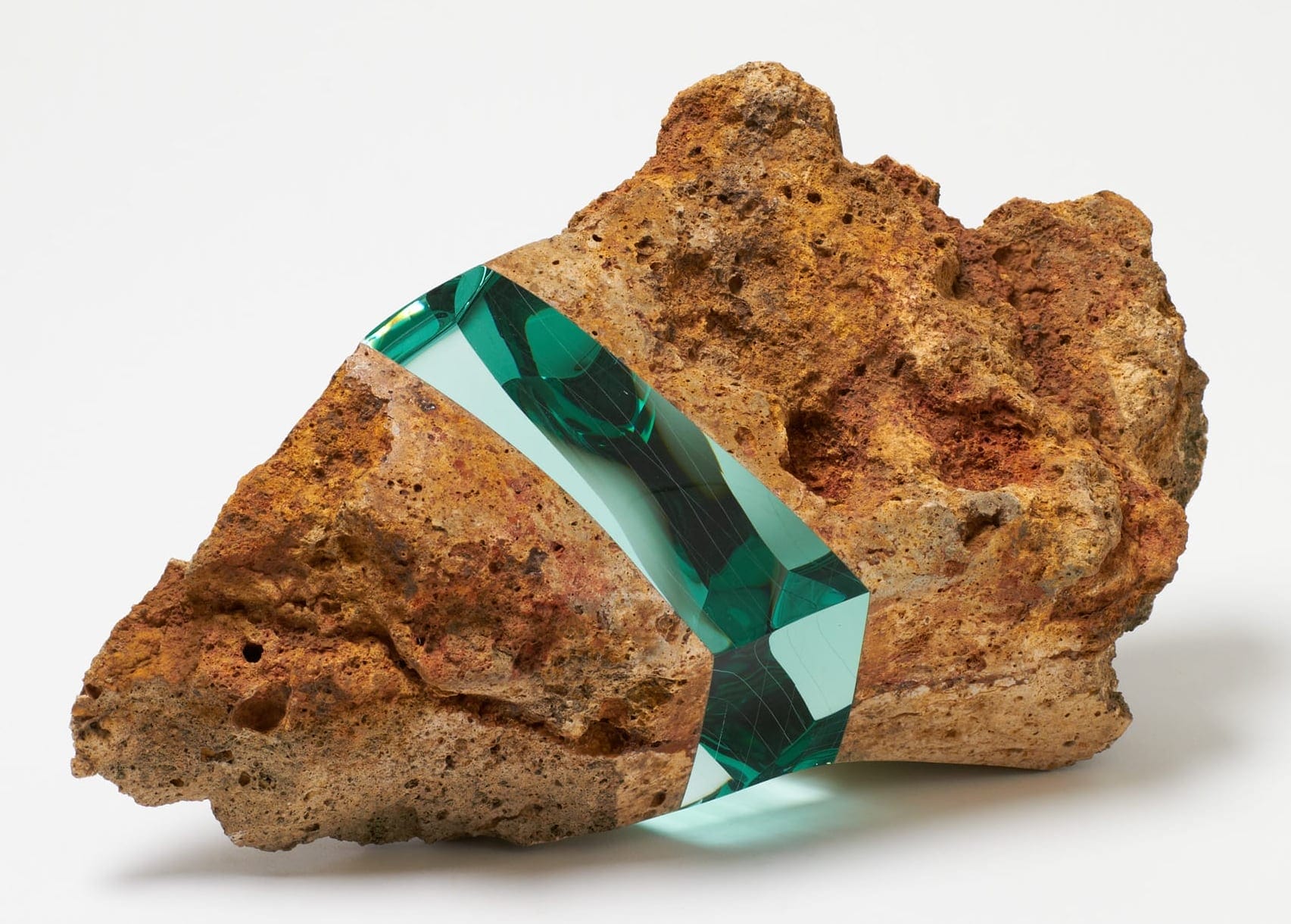 a rock including an embedded section of layered of aquamarine glass