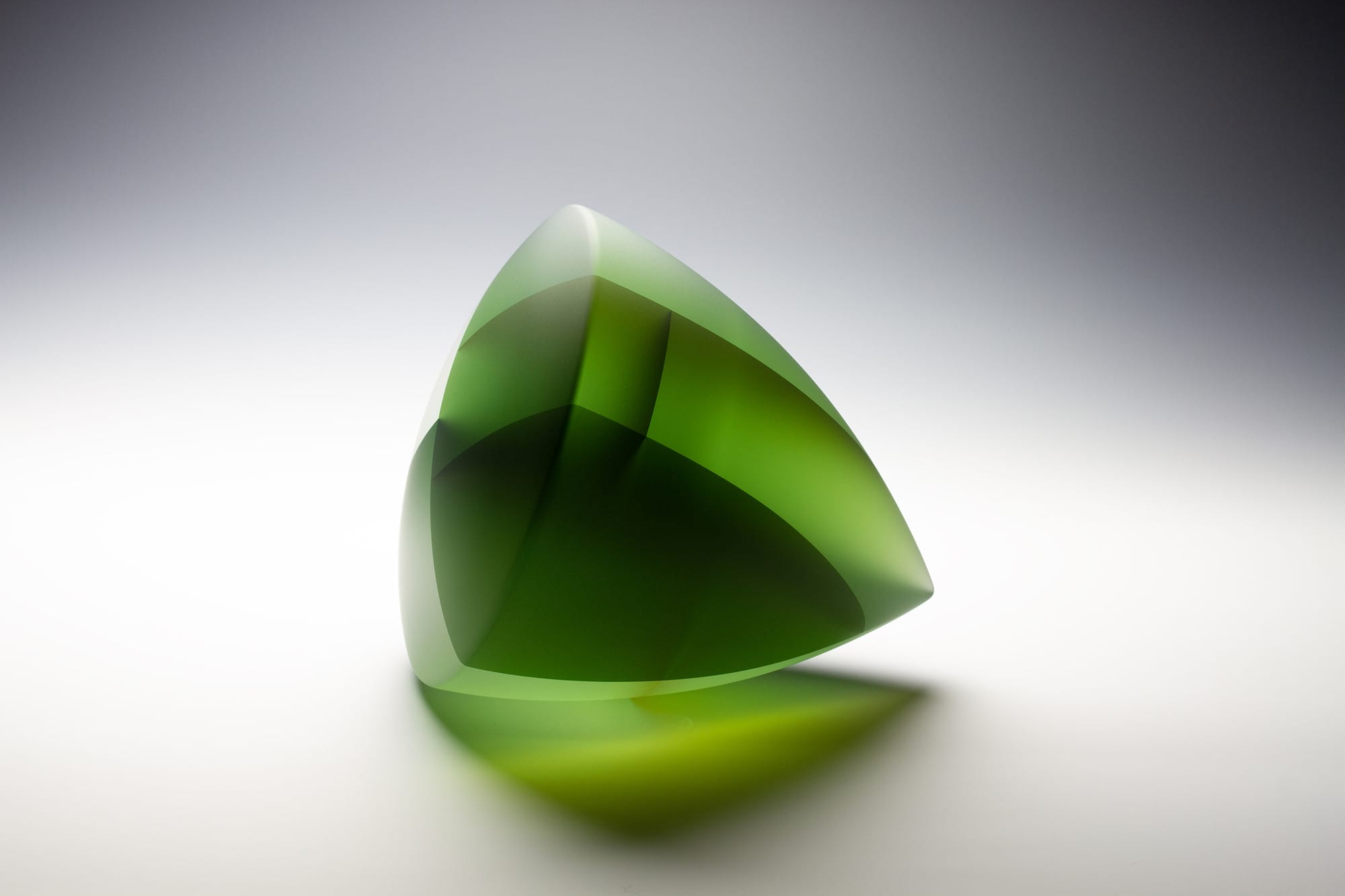 a layered, conic glass sculpture of translucent green hues