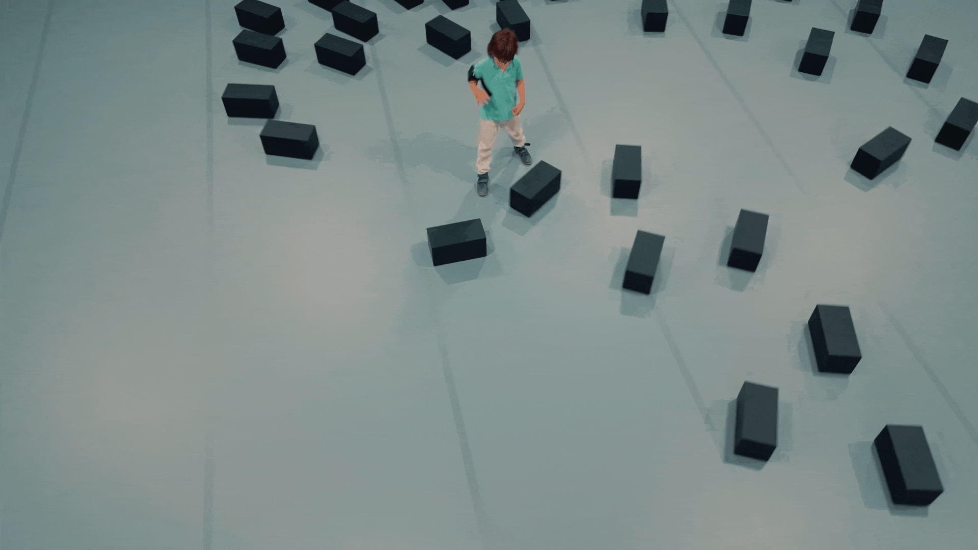 an animated gif of black rectangles chasing a small child