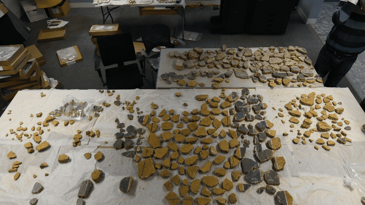 a gif of researchers arranging hundreds of pieces of an ancient Roman fresco