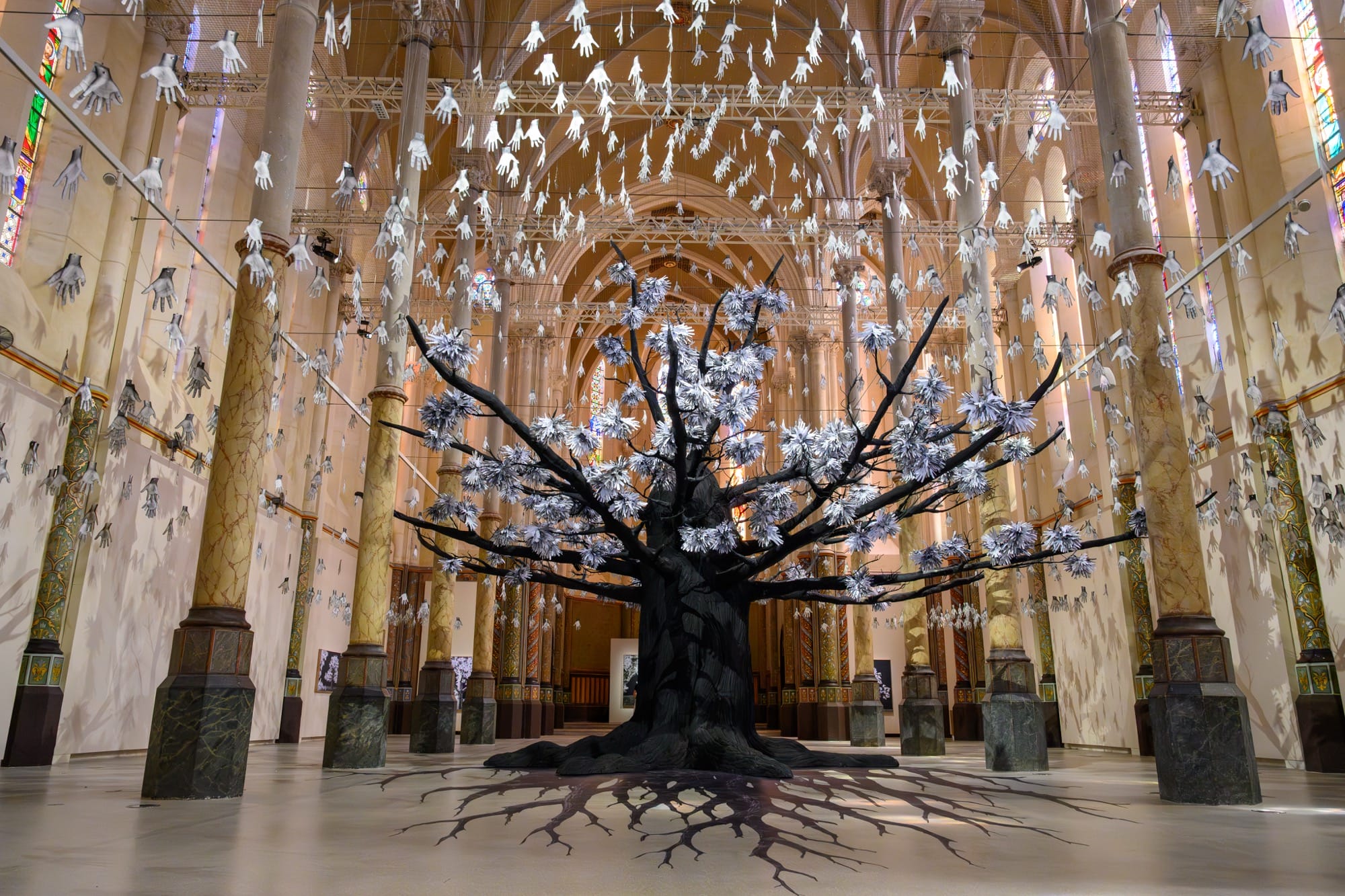 a tree installation with leaves made of hands