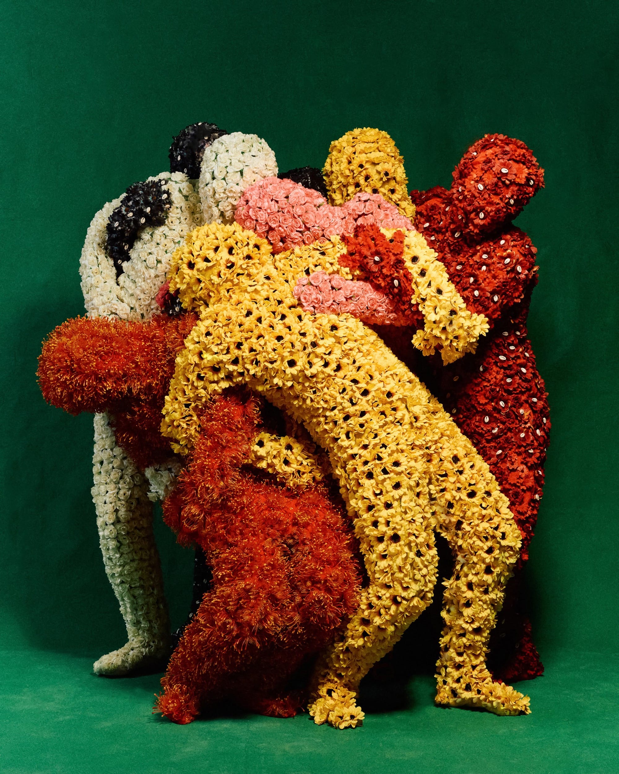 several embracing costumed figures with all-over outfits of fabric flowers