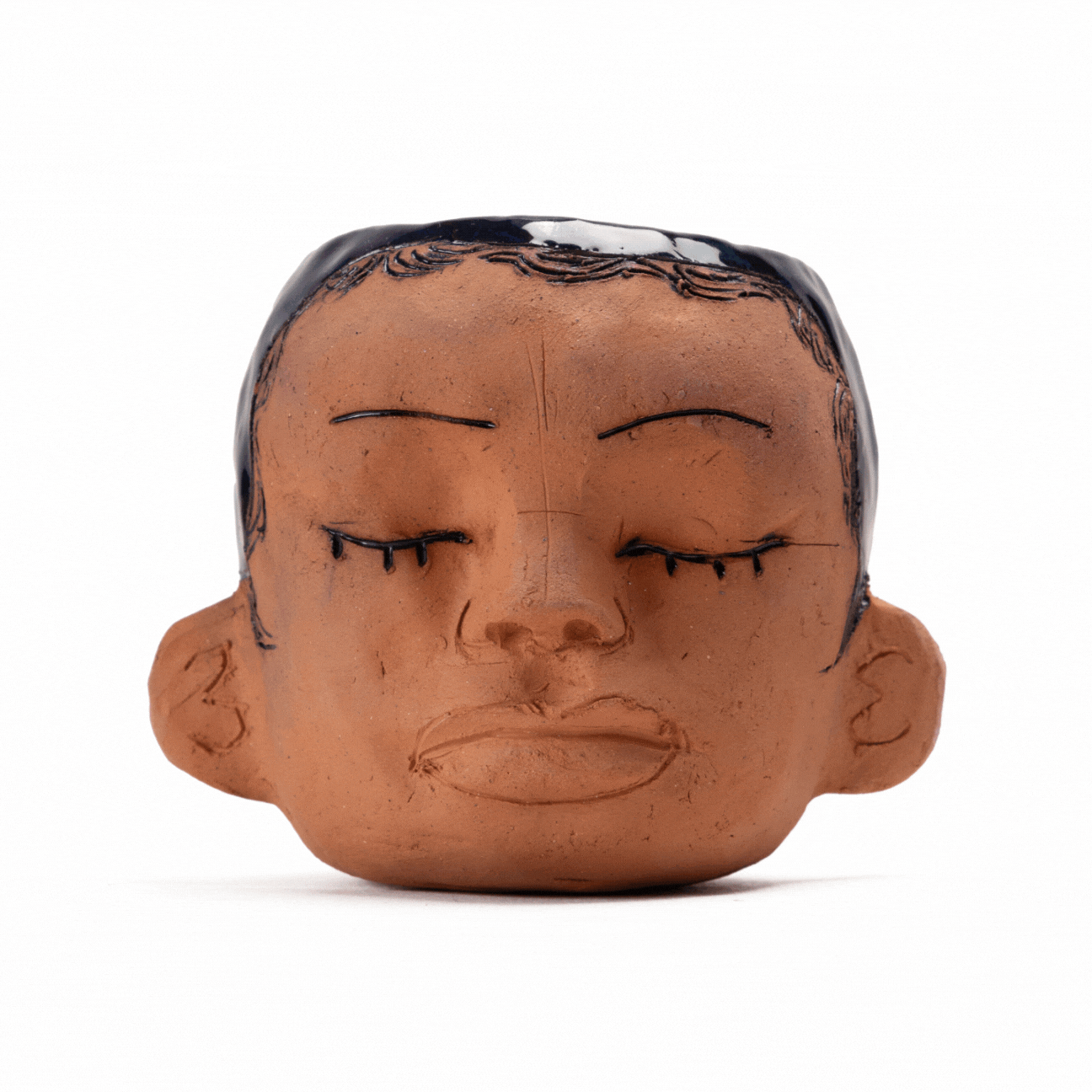 a gif of two ceramic head pots on rotation