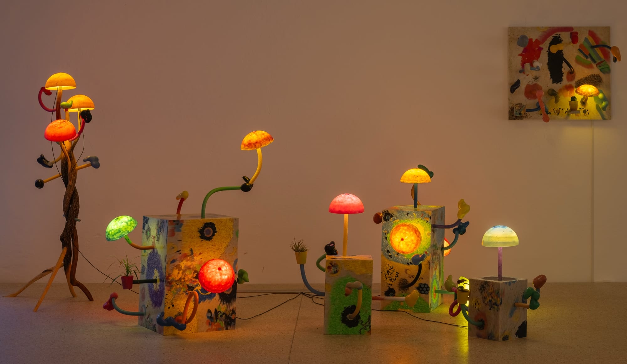 an installation of illuminated mushroom sculptures by Mika Rottenberg in a large white gallery space