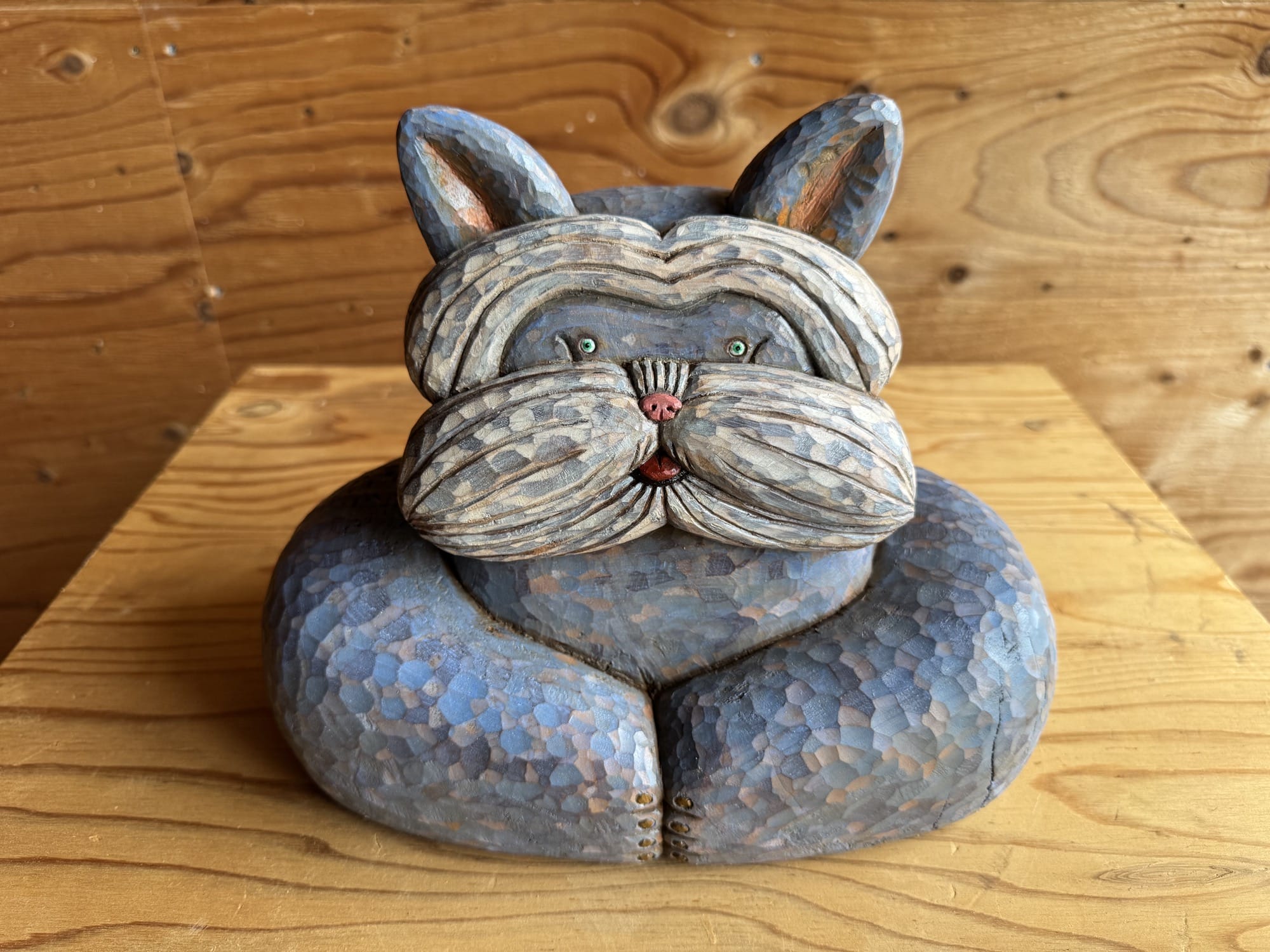 a blue painted dog sculpture by Misato Sano