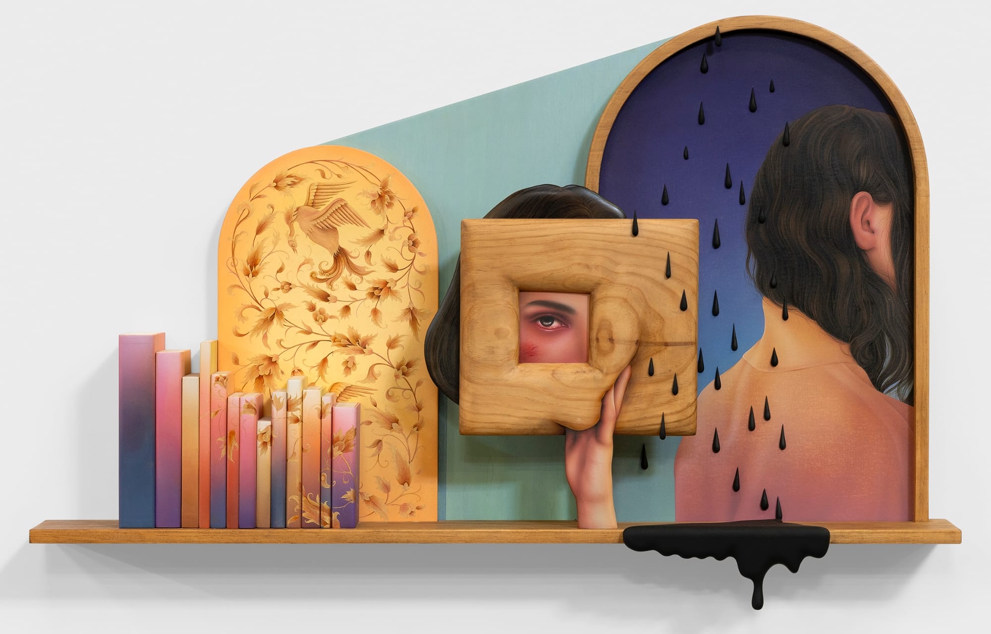 a work by Arghavan Khosravi of a woman holding up a wooden frame with an eye peering through and black raindrops surrounding them. there are colorful books and a black drip on the shelf below