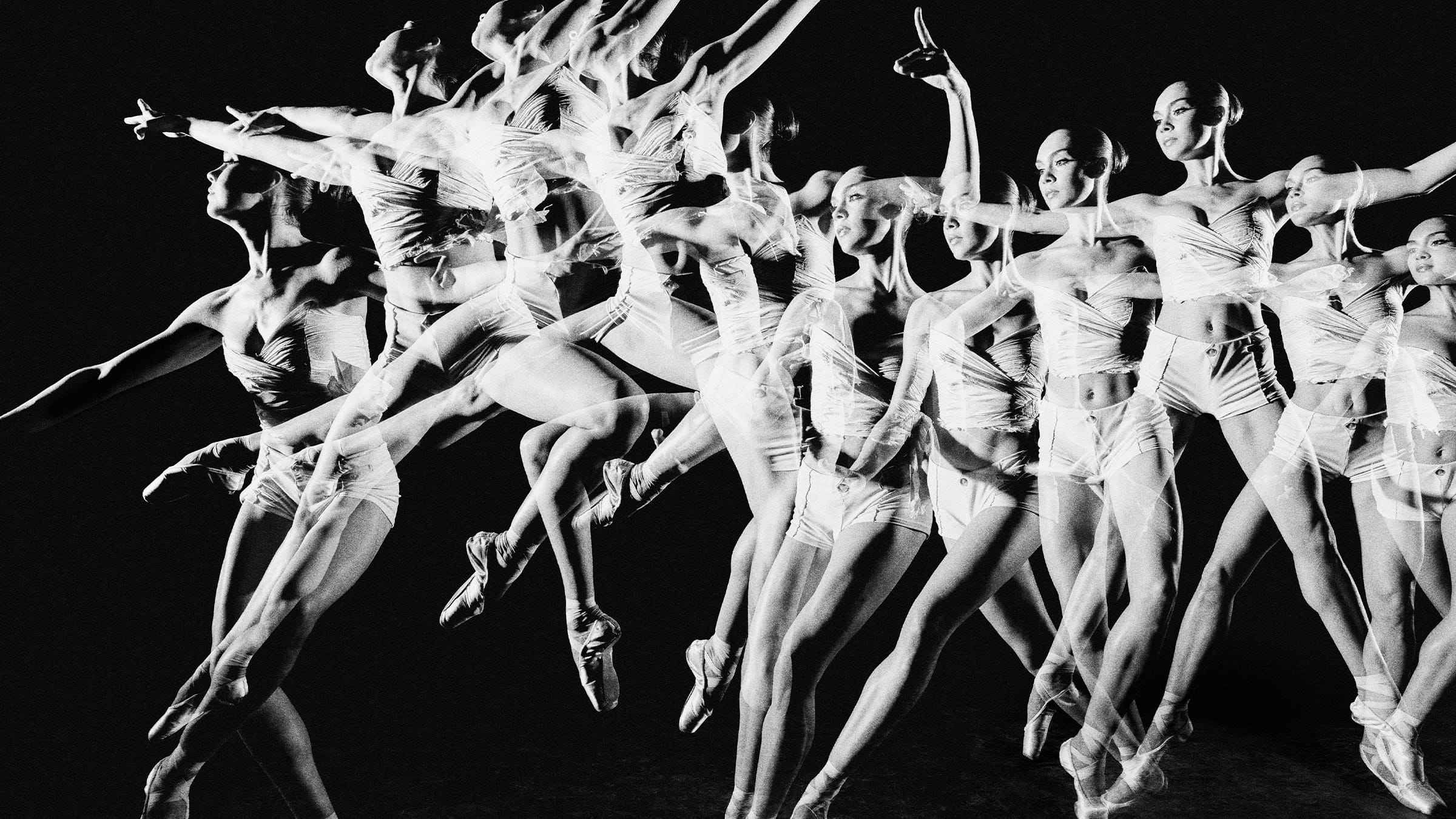 A multi-exposure, black-and-white image of ballet dancers in motion.