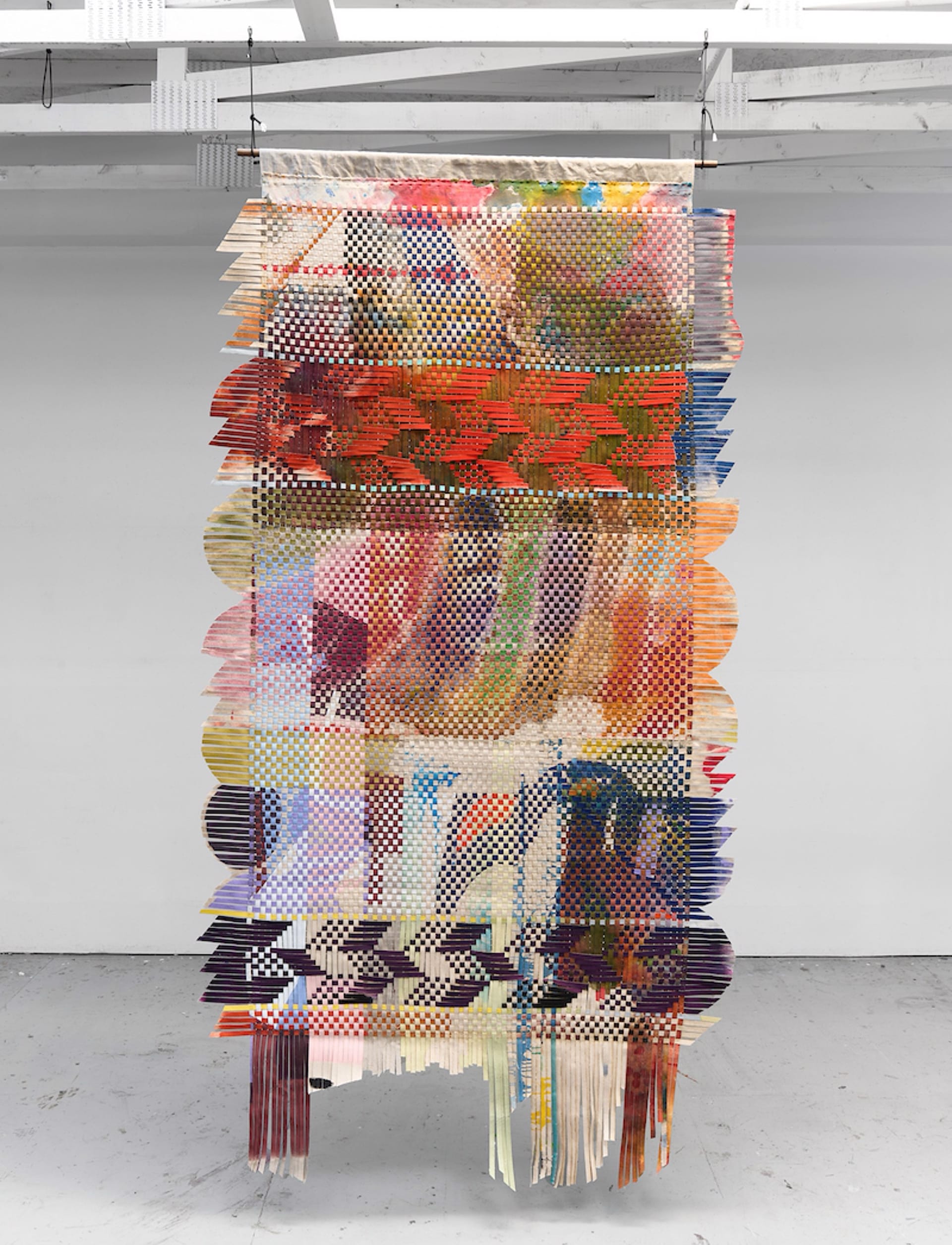 a suspended abstract woven tapestry by Miguel Arzabe