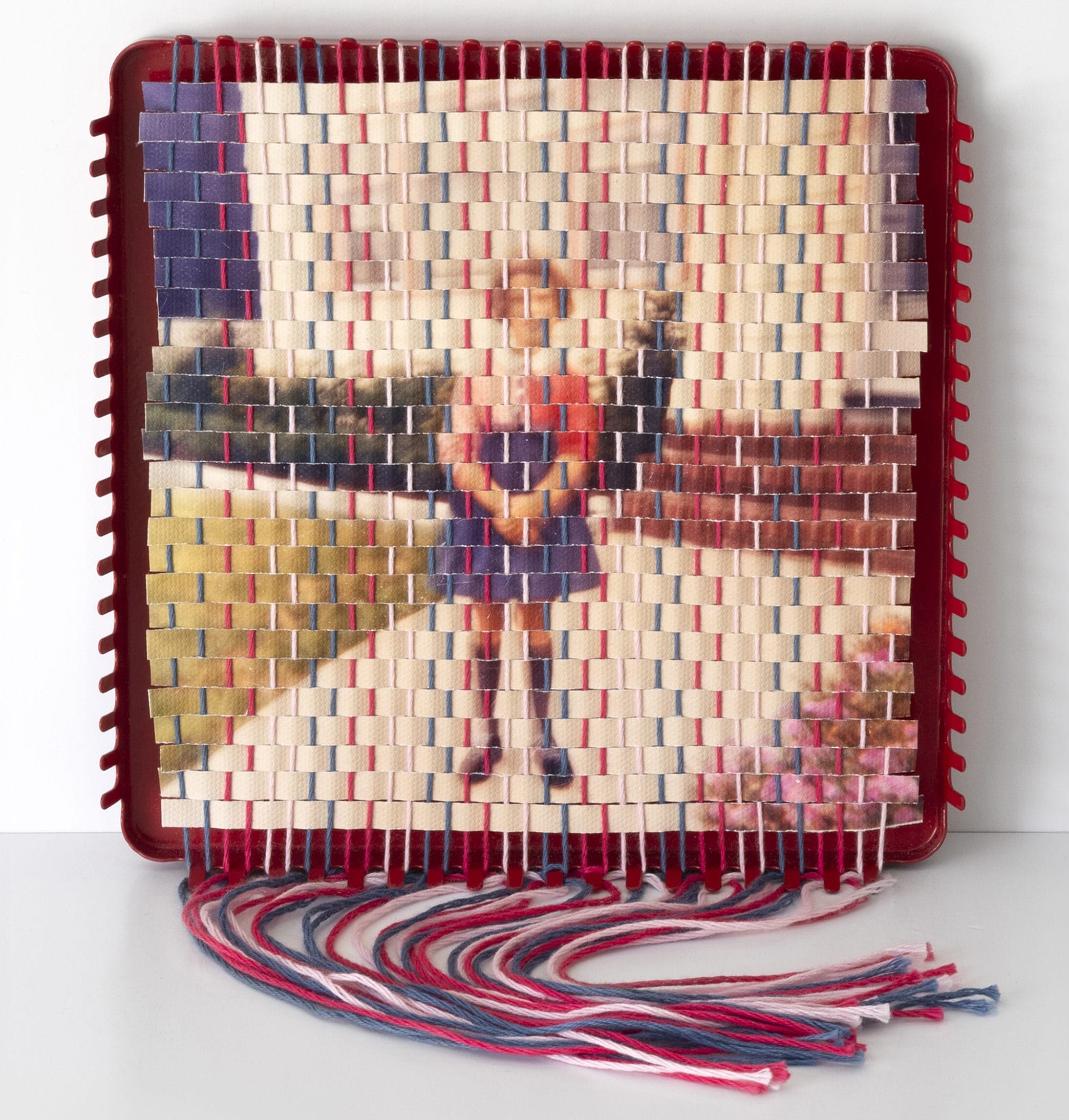 A woven reproduction of a family snapshot made on a potholder loom by Pam Connelly