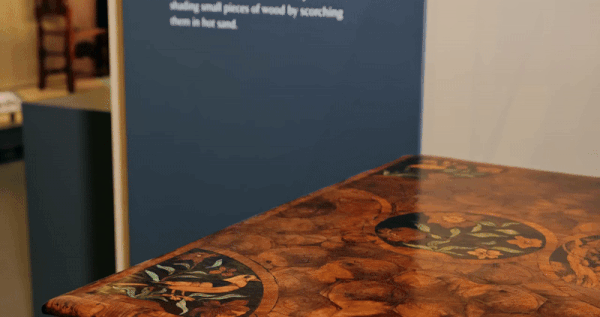 A gif from a short film produced by the V&A showing two miniature 17th-century table replicas being stacked on the original