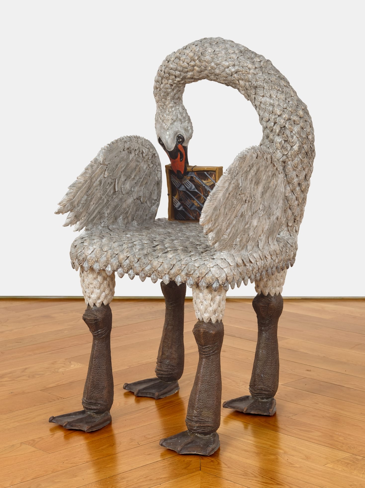 a ceramic chair sculpture by Stephanie Temma Heir shaped like a swan with a small painting embedded in its back