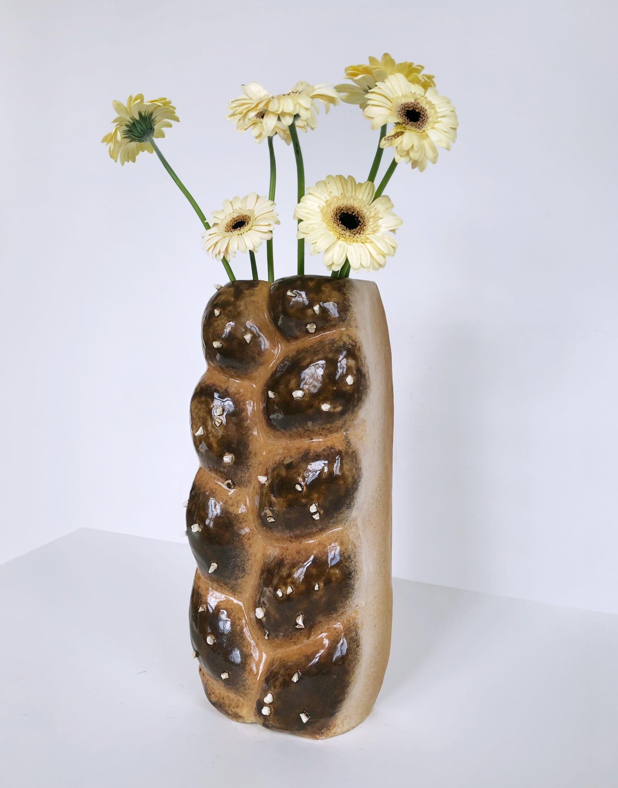 A ceramic vase by Eléonore Joulin that resembles a challah bread