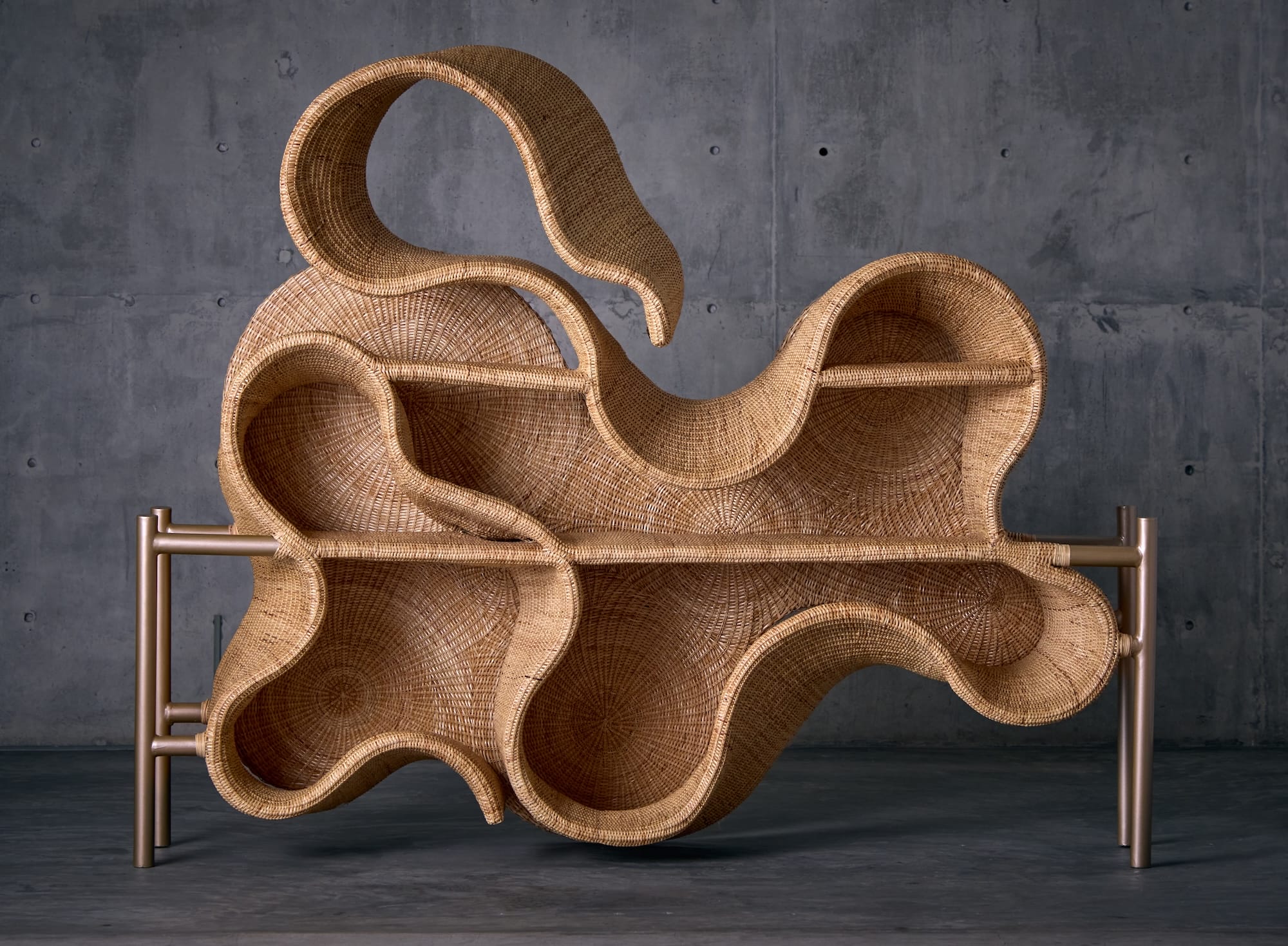 a large wicker shelving unit with undulating, rounded shapes