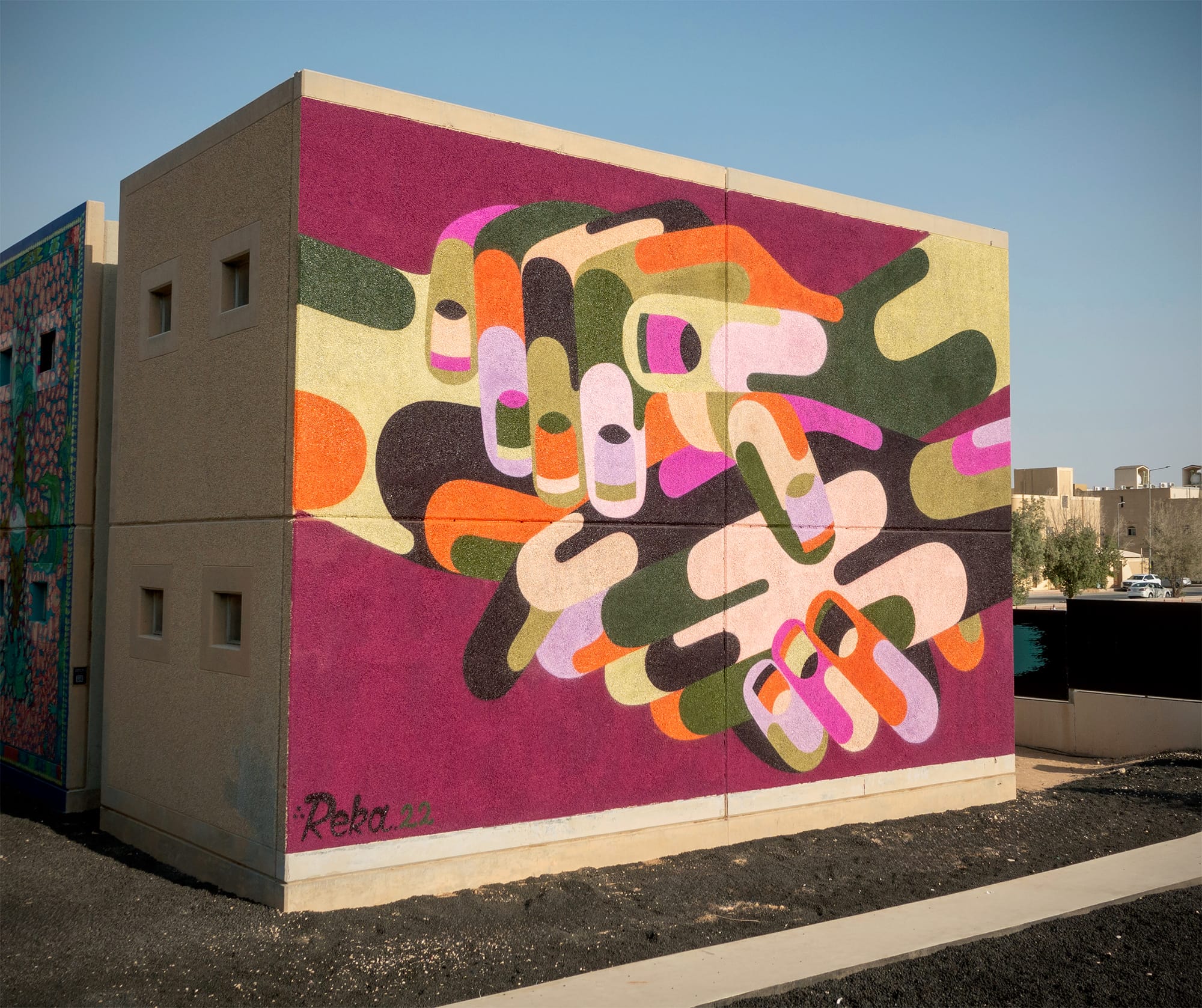 a vibrant abstracted mural of hands by James Reka