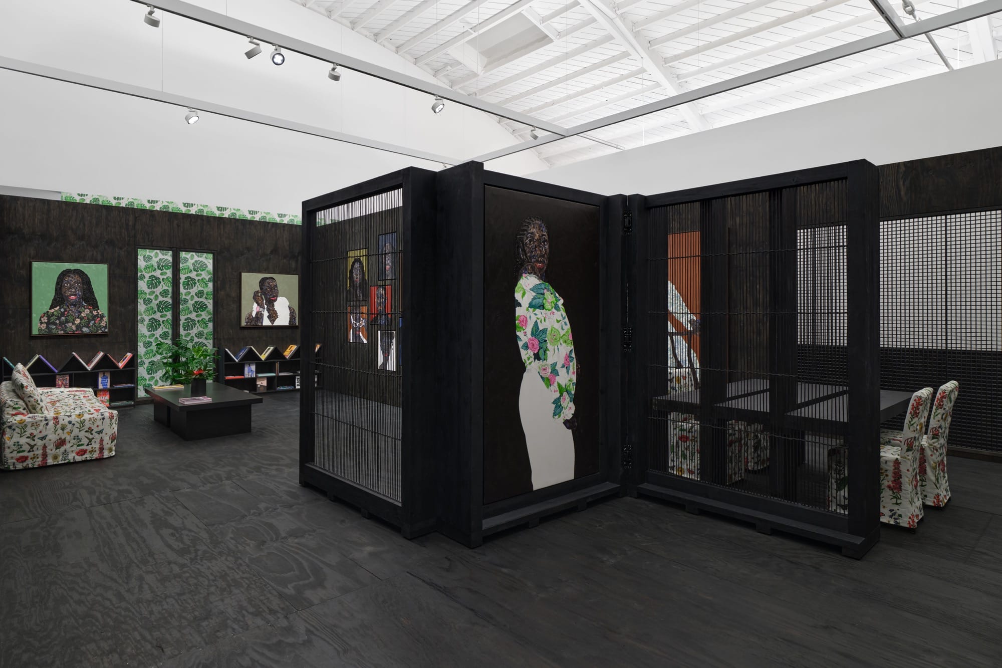 an installation view with portraits by Amoako Boafo and a patterned sofa