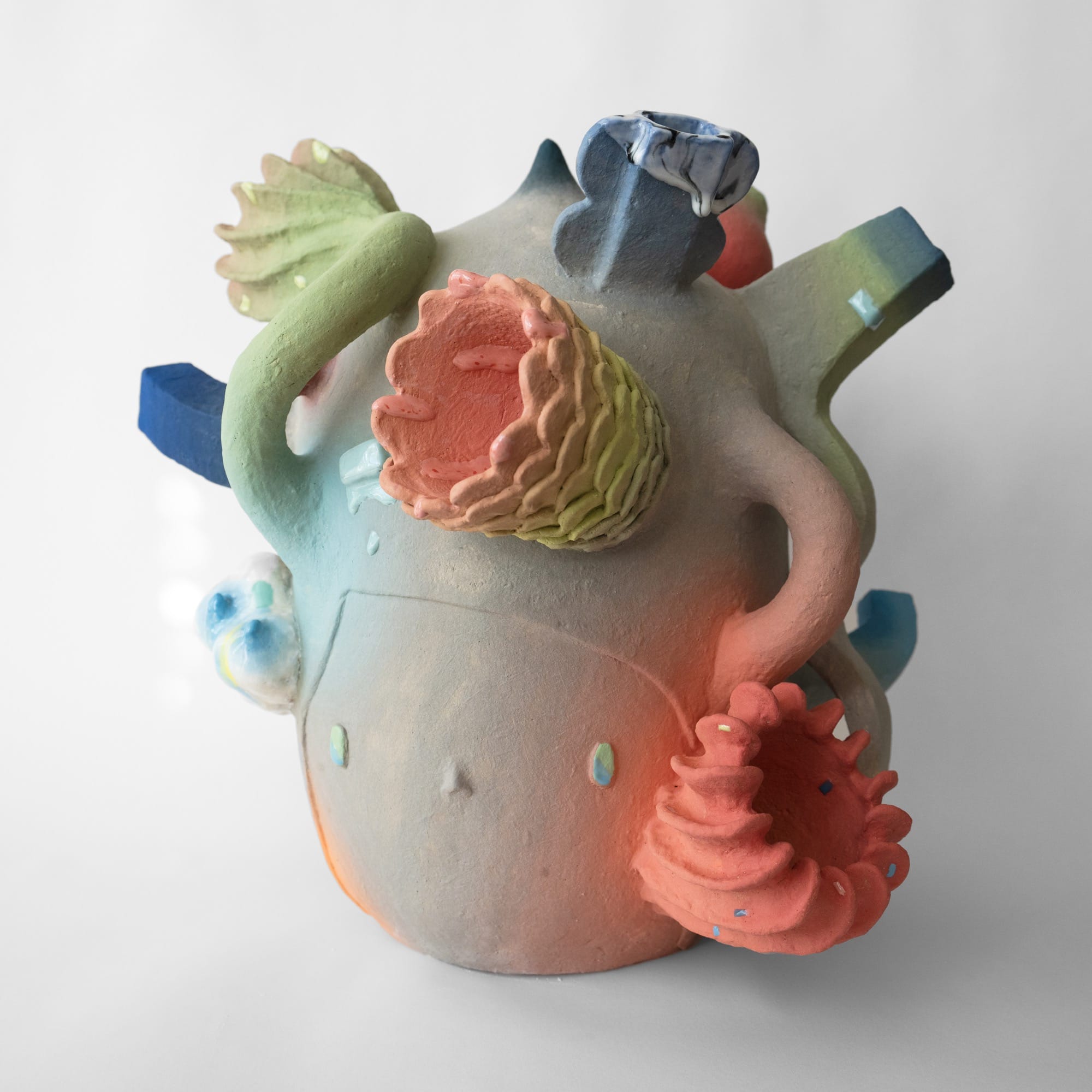a ceramic head sculpture by Janny Baek with various floral forms emerging