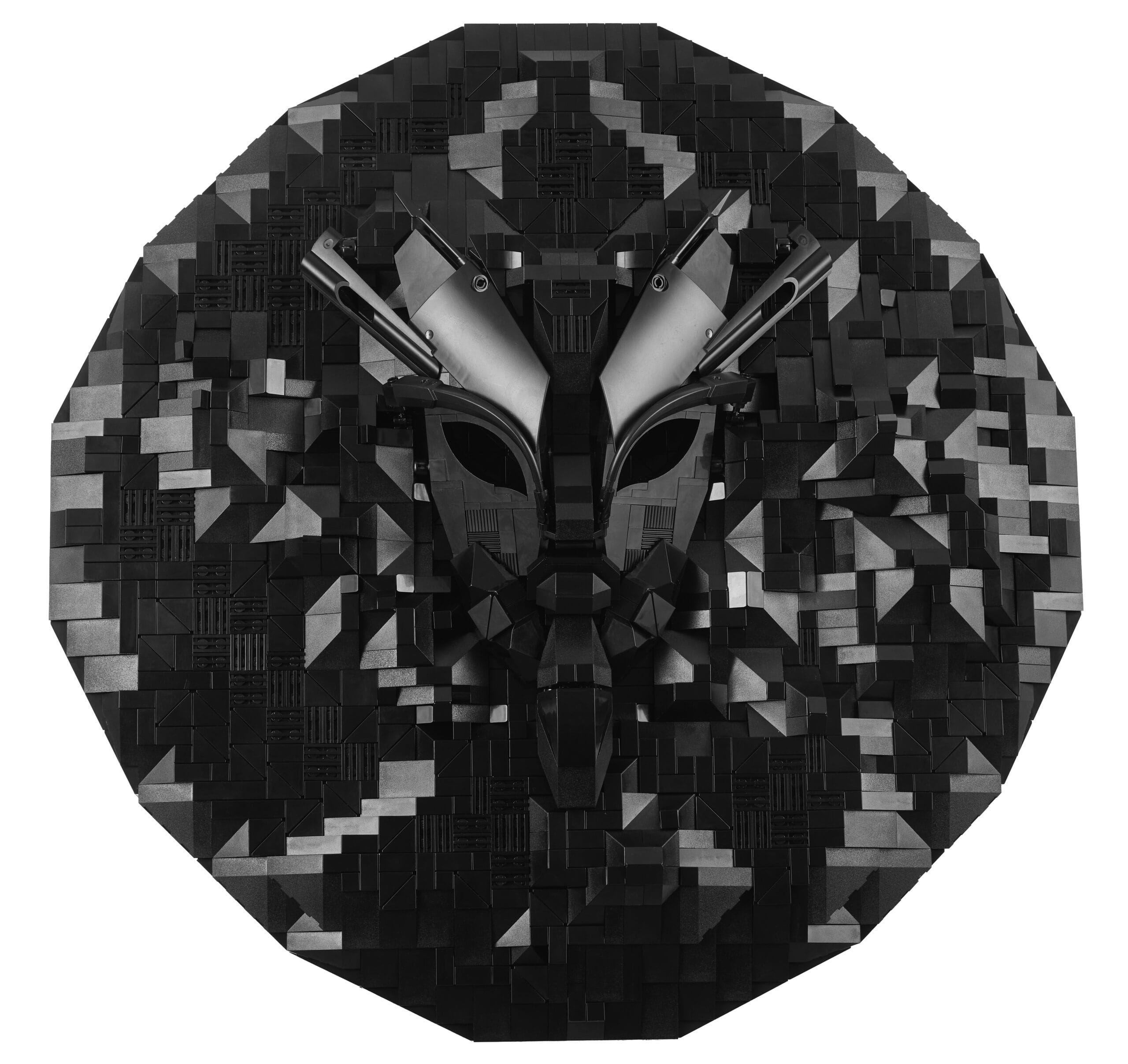 A sculpture made from black lego bricks inspired by African ceremonial masks in a circular shape