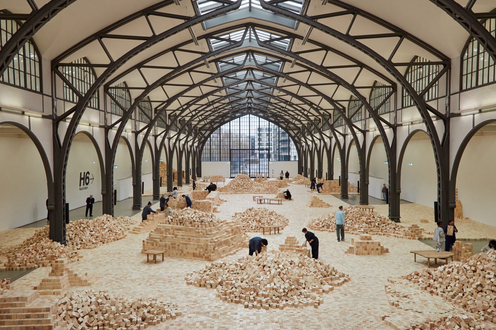 an installation of wooden blocks by Lina Lapelytė in a cavernous building