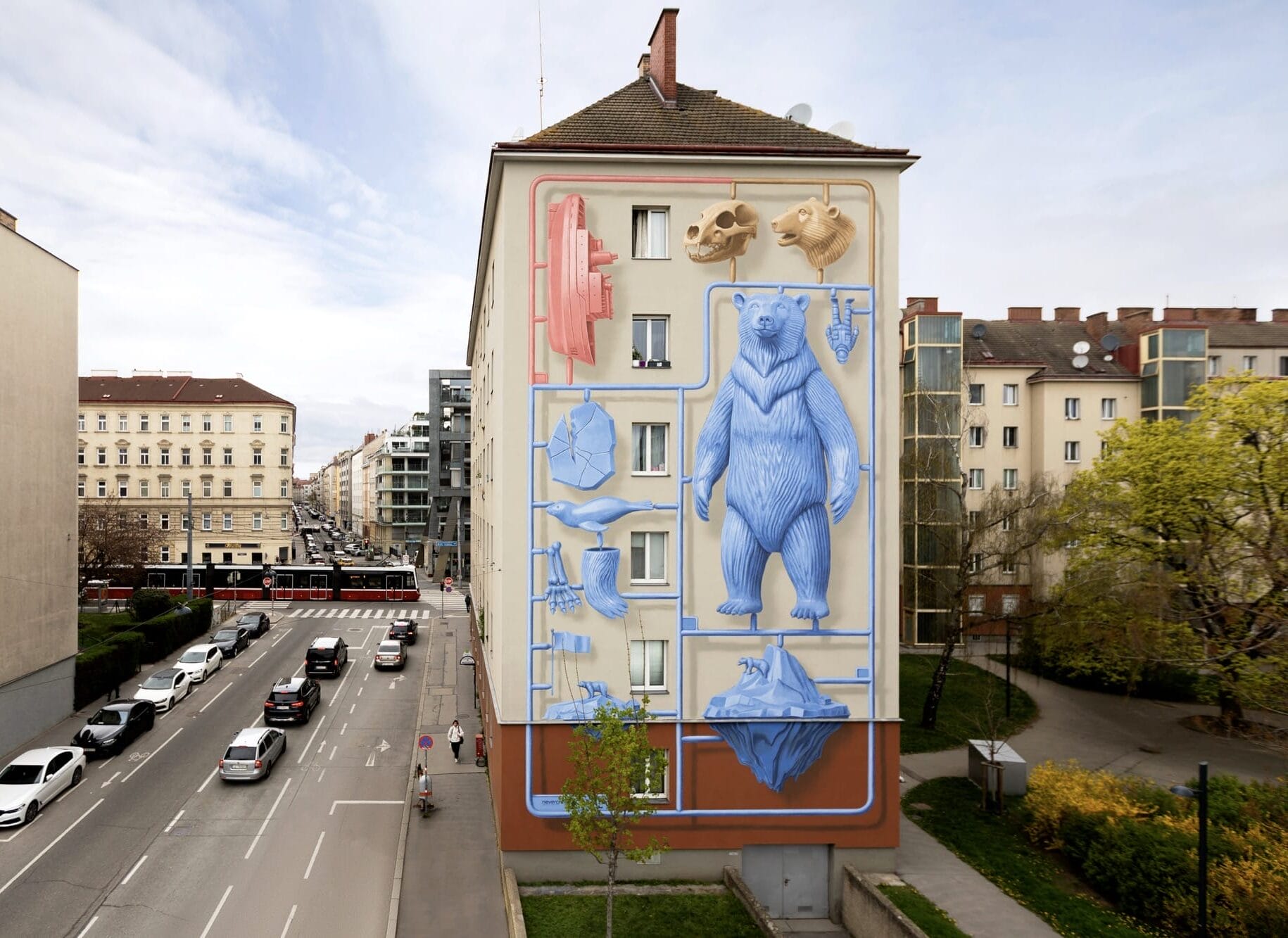 a mural by Nevercrew of a punch-out plastic toy featuring a blue bear, a ship, animal heads, and other details