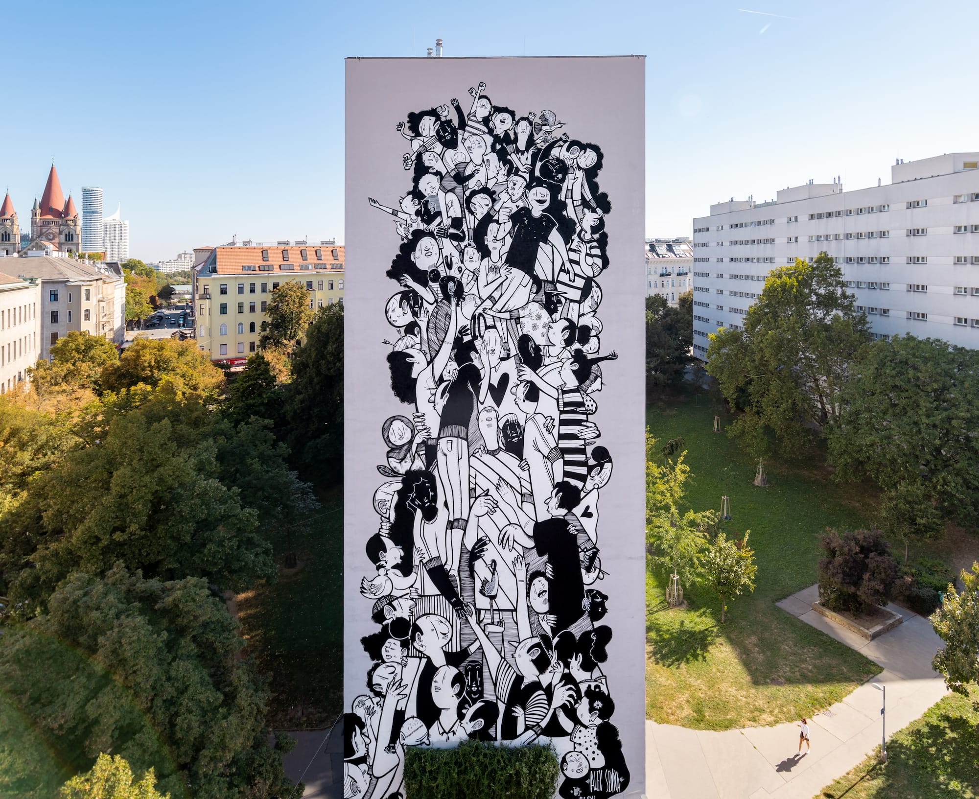 a mural by Alex Senna of a cartoonish, black-and-white composition of numerous figures grouped together on a pink background