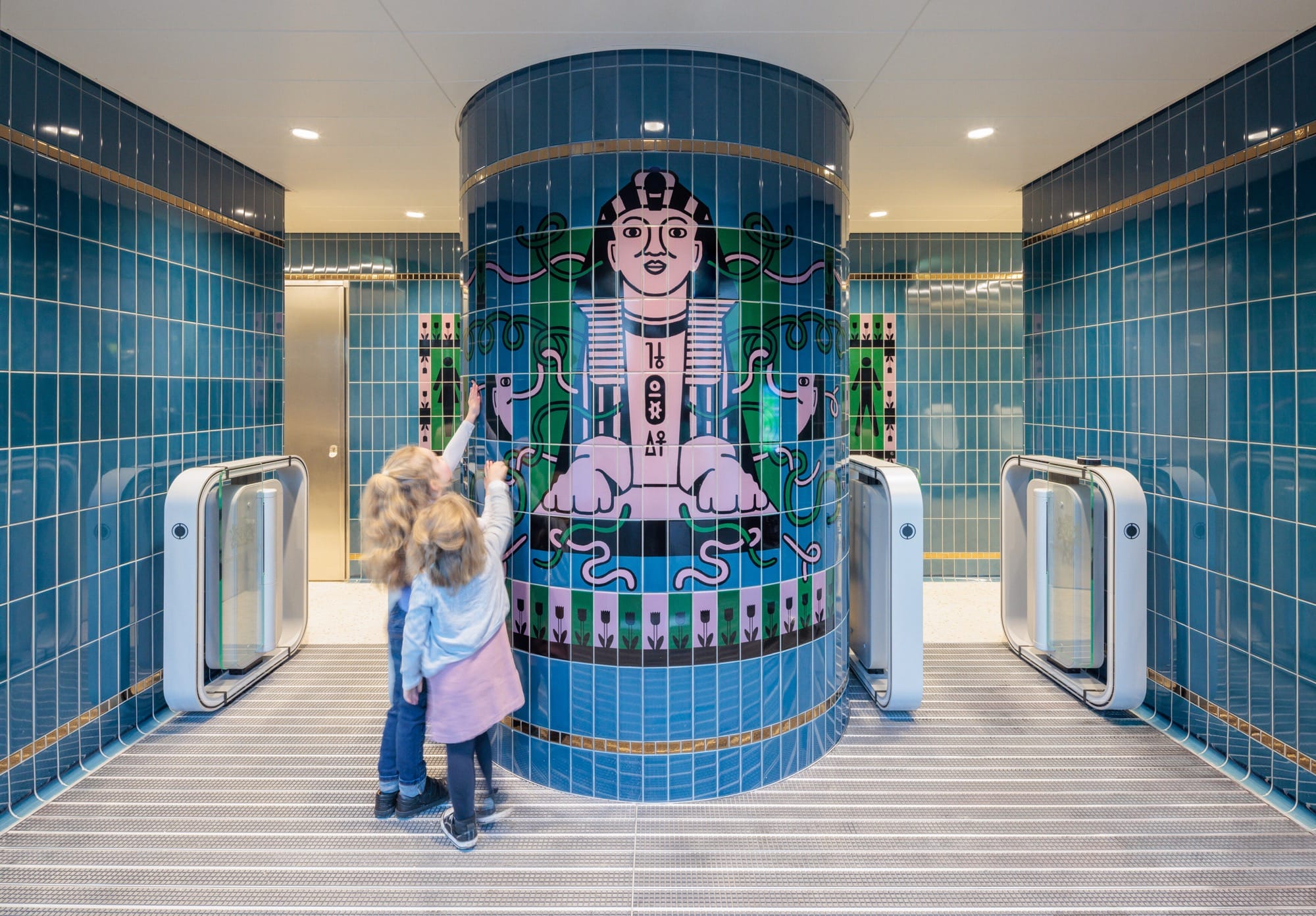 the interior of a tube station bathroom design featuring colorful tiles in London