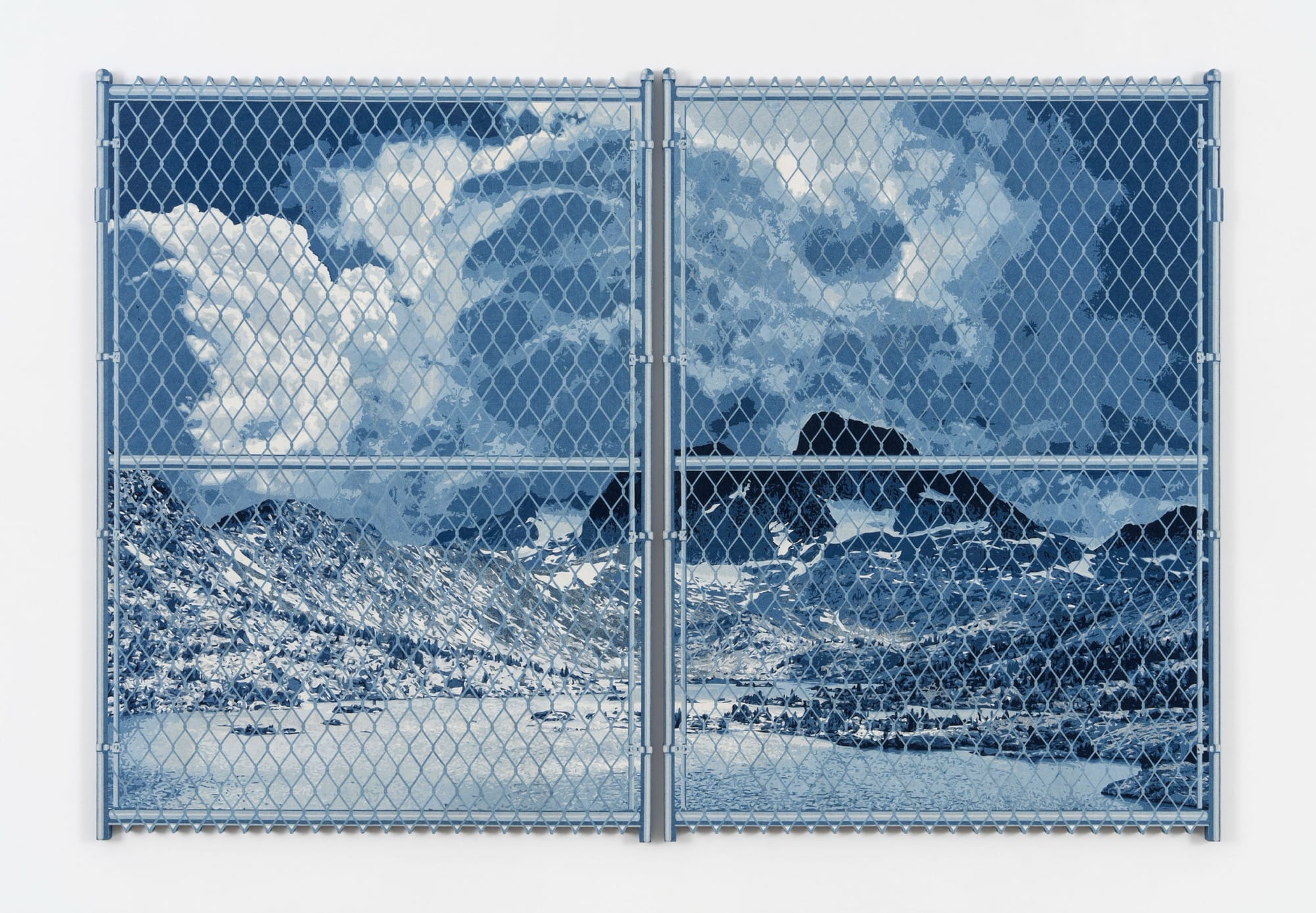 a large denim wall sculpture by Nick Doyle of a landscape behind a chain link fence
