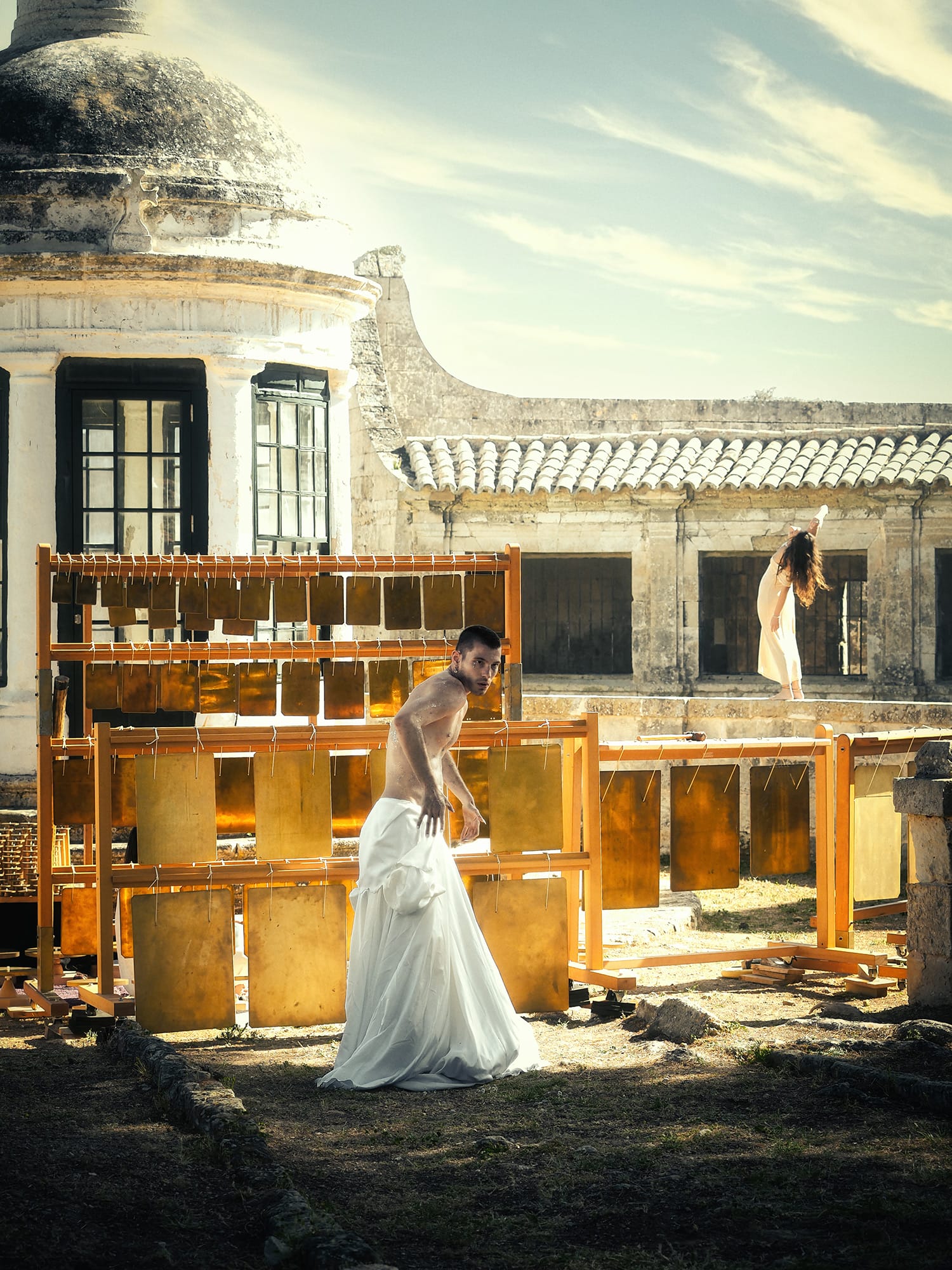 a model dances in front of a large bilas