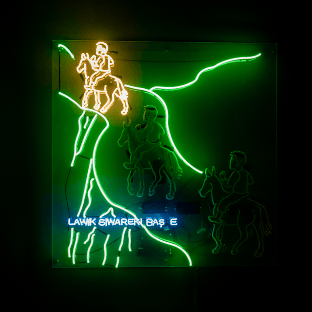 a gif of a neon sculpture by Roda Medhat depicting a boy traveling on a horse